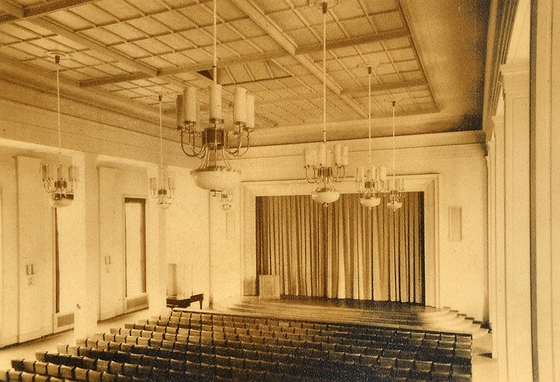 Vorlesungssaal mit Bühne und Stuhlreihen im Lektionsgebäude der FDJ-Hochschule am Bogensee